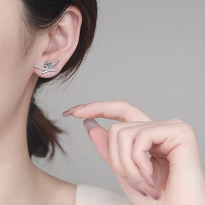 Elegant S925 sterling silver crossover stud earrings with sparkling moissanite on model