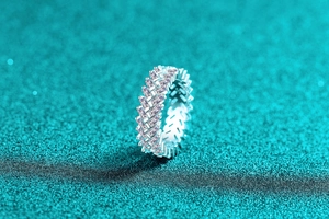 Macro detail of S925 sterling silver eternity ring with V-shaped marquise cut stones