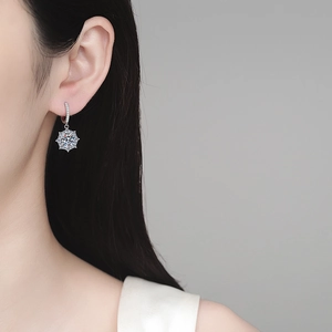 Elegant S925 sterling silver moissanite snowflake hoop earrings worn by a model
