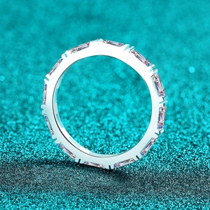 Elegant S925 sterling silver baguette cut moissanite eternity ring on teal glitter
