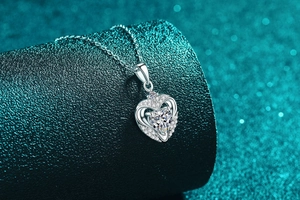 Macro shot of S925 sterling silver heart pendant with moissanite center stone detail
