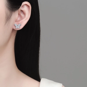 Exquisite S925 sterling silver butterfly stud earrings with sparkling moissanite on ear