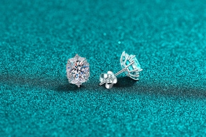 Macro shot of S925 sterling silver oval moissanite studs with sparkling halo design