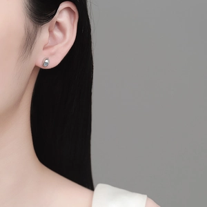 Minimalist S925 sterling silver teardrop studs with blue moissanite on ear