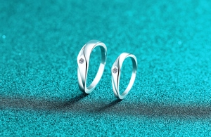 Macro shot of S925 silver couple rings with moissanite in a minimalist streamlined design