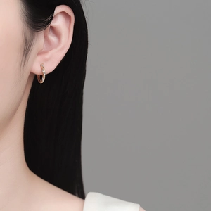 Elegant rose gold moissanite hoop earrings with pavé stones shown on model's ear