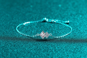 Macro shot of silver bracelet featuring a square-cut moissanite and delicate fine chain