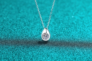 Macro view of water drop S925 silver pendant with sparkling Moissanite gemstone