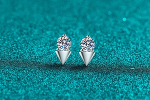 Macro shot of 925 silver moissanite stud earrings featuring three-prong geometric settings