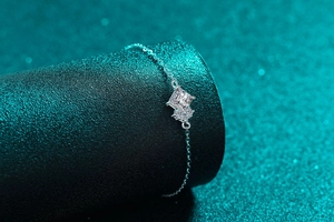 Macro shot of S925 sterling silver bracelet featuring a square moissanite stone