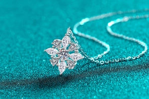 Macro shot of S925 sterling silver floral pendant with marquise and pear-cut moissanite