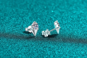 Macro detail of S925 sterling silver moissanite earrings with geometric triangle design