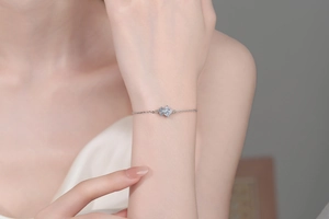 Detailed view of S925 sterling silver bracelet with linked diamond-set rhombus charms