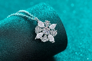 Macro shot of a floral S925 sterling silver necklace featuring marquise cut moissanite stones