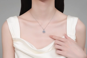 Macro view of emerald-cut blue moissanite pendant necklace on a silver chain