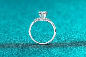 Macro view of S925 sterling silver moissanite ring with intricate lace heart detailing