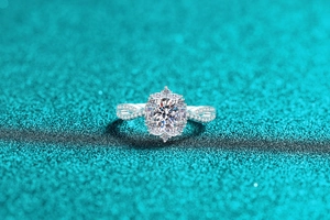 Macro shot of S925 silver oval moissanite ring with halo stones and twisted pavé band