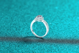 Macro view of oval moissanite ring with S925 silver setting and side stones