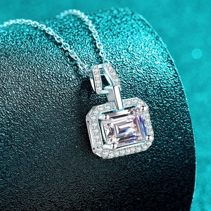 S925 sterling silver moissanite necklace with emerald-cut pendant on a dark texture background