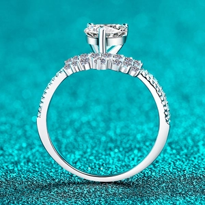 S925 sterling silver moissanite ring with round solitaire diamond on blue sand background