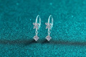 Detail of S925 sterling silver drop earrings with moissanite clovers and round cut stones