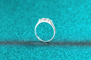 Detailed view of three round moissanite stones set in a sleek silver S925 band