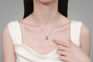 Elegant pear-shaped moissanite pendant necklace shown on a model for daily wear