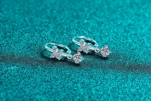 Macro view of S925 sterling silver moissanite drop earrings with flower detail