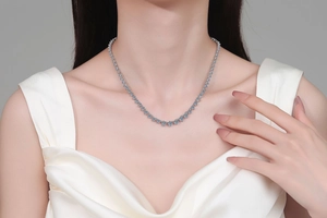 Detail of S925 sterling silver moissanite tennis necklace worn on neck for layering