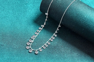Macro shot of S925 sterling silver moissanite choker with dangling round pendants