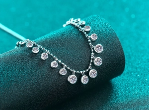 Macro shot of S925 sterling silver beaded bracelet with bezel-set moissanite charms