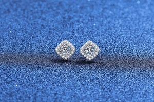 Macro shot of silver square halo stud earrings with brilliant-cut moissanite stones