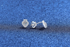 Detail of S925 sterling silver heart earrings featuring moissanite center and halo stones