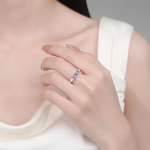 Elegant S925 sterling silver wave ring with three light blue moissanite stones on hand