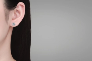 Close-up of square moissanite stud earring in S925 sterling silver worn by a model