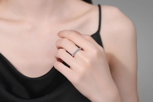 Close-up of a slim S925 sterling silver ring with delicate pave moissanite diamonds