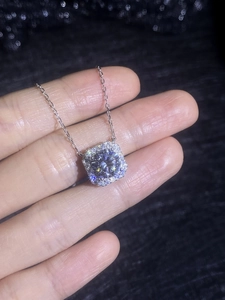 Macro view of S925 silver cushion-cut moissanite pendant with a shimmering halo setting