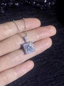 Macro view of sterling silver square halo pendant with brilliant moissanite stone