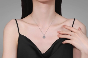 Detailed shot of S925 silver double ring pendant with moissanite on a female neck