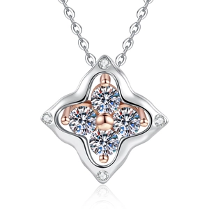 Macro shot of silver and rose gold clover pendant with sparkling zircon gemstones