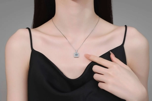 Close-up of a s925 silver square moissanite pendant necklace worn by a model