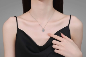Detail view of s925 silver bee necklace with moissanite on model's neck for elegant look