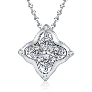 Macro shot of silver four-leaf clover pendant with sparkling moissanite stones and geometric detail
