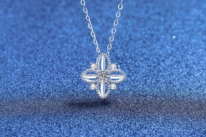 Detail of silver clover pendant necklace with moissanite center stone and pavé setting
