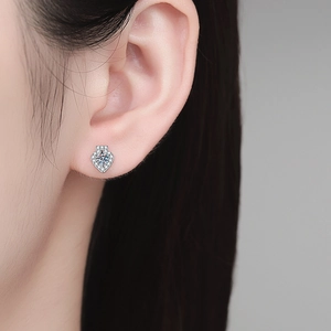 Elegant S925 sterling silver heart-shaped moissanite stud earrings on a model ear