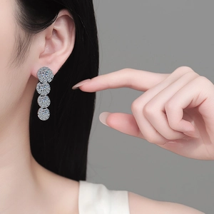 Luxurious S925 sterling silver drop earrings with moissanite crystals on a model