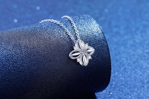 Detailed view of S925 sterling silver four-leaf clover pendant with moissanite center stone