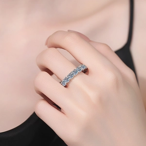 Sparkling S925 sterling silver moissanite eternity ring band on a woman's hand