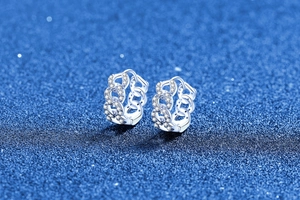 Macro view of S925 silver Cuban link hoop earrings with sparkling micro-pave zircons