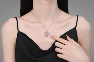 Close-up of S925 silver moissanite necklace with double circular pendant on a model